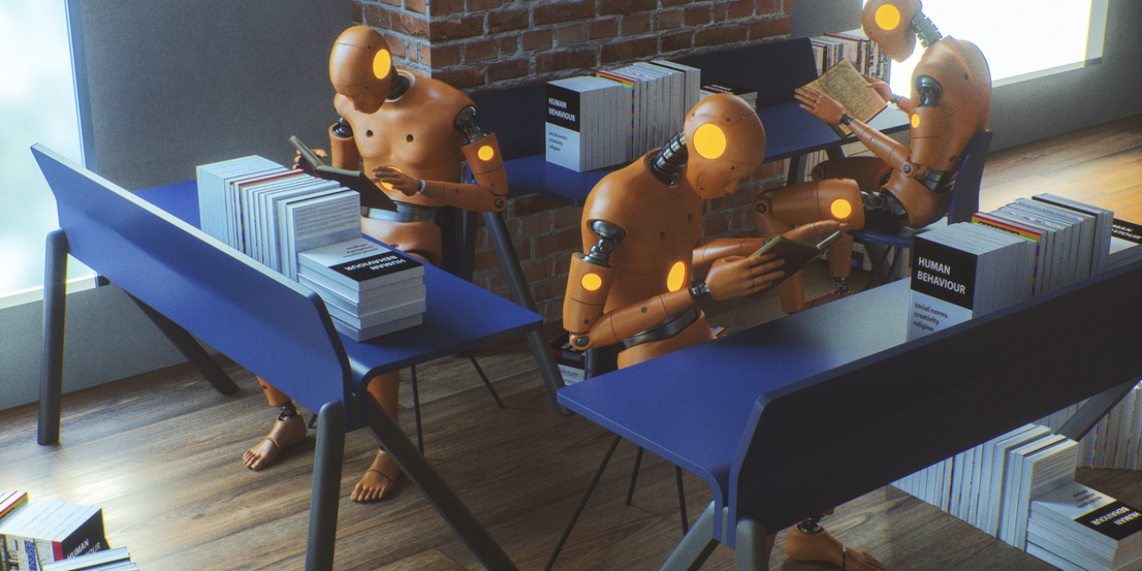 Three robotic forms sat at desks reading manuals on human behaviour