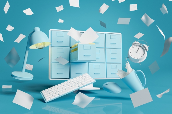Illustration in turquoise, blue and white representing office chaos. A computer monitor displays a filing cabinet, from which paper work spills out. Objects float around the monitor: a cup with liquid spilling, a keyboard, lamp and alarm clock.